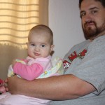 Holly and Daddy. She loves to sit up.