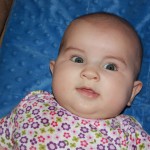 Her blue eyes match the blanket!